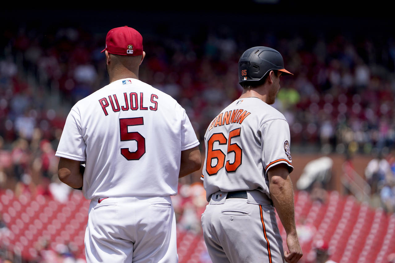 Baltimore Orioles' Rylan Bannon (65) stands next to St. Louis Cardinals first baseman Albert Pujols...