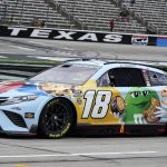 
              Kyle Busch (18) drives on pit row during qualifying laps for a NASCAR All-Star auto race at Texas Motor Speedway in Fort Worth, Texas, Saturday, May 21, 2022. (AP Photo/Larry Papke)
            