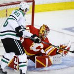 
              Dallas Stars defenceman Ryan Suter, left, has his shot grabbed by Calgary Flames goalie Jacob Markstrom during the second period of Game 1 of an NHL hockey first-round playoff series Tuesday, May 3, 2022, in Calgary, Alberta. (Jeff McIntosh/The Canadian Press via AP)
            