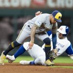 
              Milwaukee Brewers second baseman Kolten Wong, top, tags out Atlanta Braves' Adam Duvall (14) during the eighth inning of a baseball game Saturday, May 7, 2022, in Atlanta. (AP Photo/Hakim Wright Sr)
            
