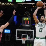 
              Boston Celtics forward Jayson Tatum (0) shoots over Miami Heat forward Caleb Martin (16) during the second half of Game 4 of the NBA basketball playoffs Eastern Conference finals, Monday, May 23, 2022, in Boston. (AP Photo/Charles Krupa)
            
