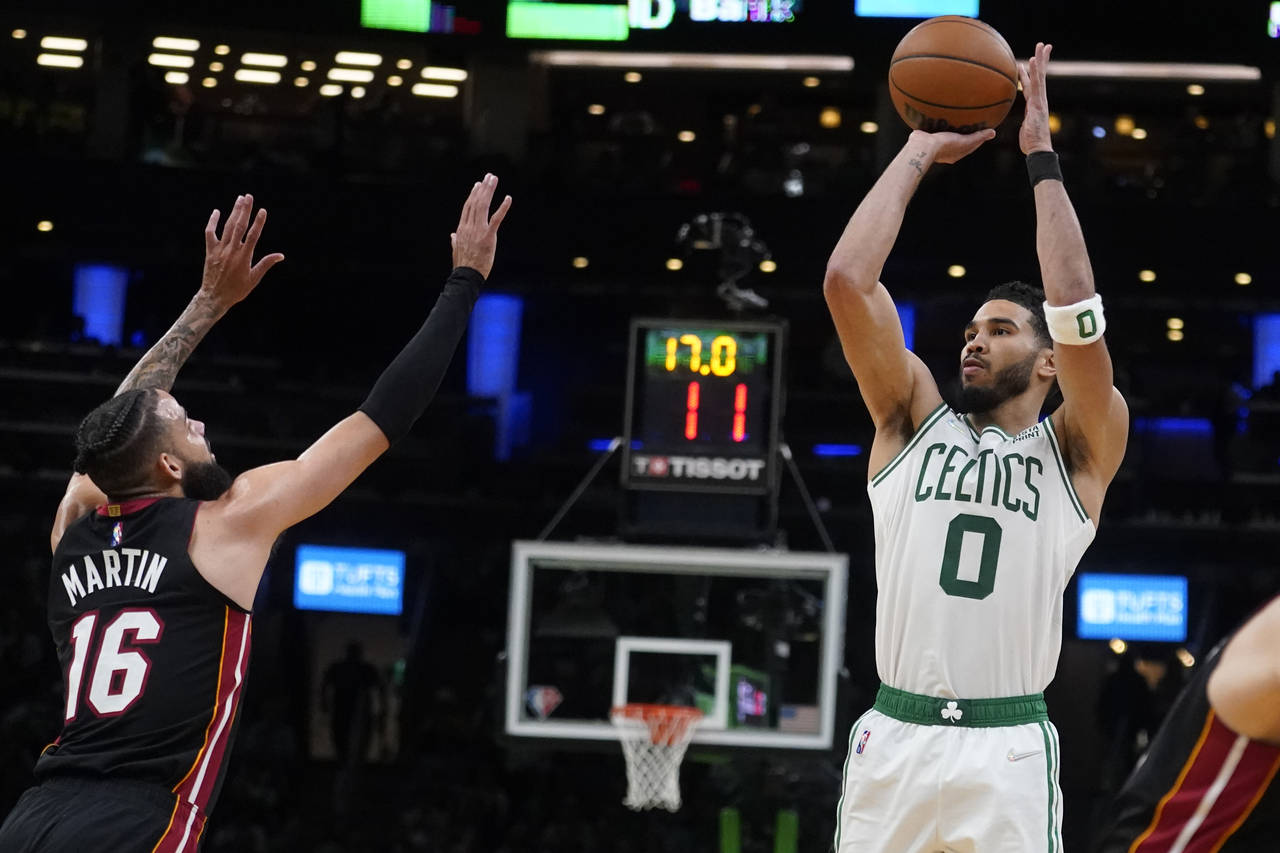 Boston Celtics forward Jayson Tatum (0) shoots over Miami Heat forward Caleb Martin (16) during the...