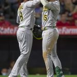 
              Oakland Athletics' Jed Lowrie, left, celebrates with Seth Brown at the plate after Brown hit a two-run home run against the Los Angeles Angels during the fifth inning of a baseball game in Anaheim, Calif., Friday, May 20, 2022. (AP Photo/Alex Gallardo)
            