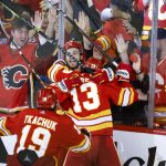 
              Calgary Flames forward Johnny Gaudreau (13) celebrates his goal with teammates during overtime NHL playoff hockey action against the Dallas Stars in Calgary, Alberta, Sunday, May 15, 2022. (Jeff McIntosh/The Canadian Press via AP)
            