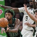 
              Boston Celtics guard Marcus Smart (36), left, passes the ball as Milwaukee Bucks center Bobby Portis (9) and guard Grayson Allen, right, try to defend the first half of Game 1 in the second round of the NBA Eastern Conference playoff series, Sunday, May 1, 2022, in Boston. (AP Photo/Steven Senne)
            