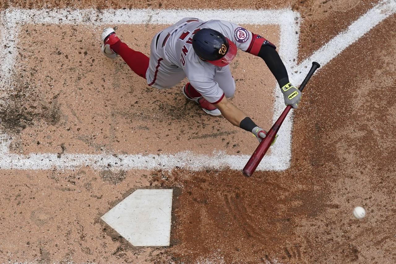 Washington Nationals' Cesar Hernandez bunts for an RBI single during the fourth inning of a basebal...