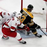 
              Boston Bruins' Charlie Coyle (13) scores on Carolina Hurricanes' Pyotr Kochetkov (52) during the first period of Game 3 of an NHL hockey Stanley Cup first-round playoff series Friday, May 6, 2022, in Boston. (AP Photo/Michael Dwyer)
            