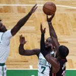 
              Boston Celtics center Robert Williams III (44) tries to block a shot by Miami Heat forward Jimmy Butler, right, during the first half of Game 4 of the NBA basketball playoffs Eastern Conference finals, Monday, May 23, 2022, in Boston. Celtics guard Jaylen Brown (7) looks on. (AP Photo/Charles Krupa)
            