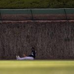 
              Chicago White Sox's Luis Robert sits on the warning track after catching Chicago Cubs' Willson Contreras's fly ball while running into the centerfield wall to end the sixth inning of a baseball game Wednesday, May 4, 2022, in Chicago. (AP Photo/Charles Rex Arbogast)
            