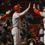 
              Los Angeles Angels' Jared Walsh, right, is greeted at home plate by Anthony Rendon (6) and Shohei Ohtani after his three-run home run against the Boston Red Sox during the 10th inning of a baseball game Wednesday, May 4, 2022, at Fenway Park in Boston. (AP Photo/Winslow Townson)
            