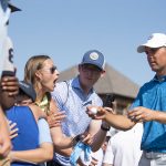 
              Jordan Spieth hands golf balls to fans after completing the third round of the AT&T Byron Nelson golf tournament in McKinney, Texas, on Saturday, May 14, 2022. (AP Photo/Emil Lippe)
            