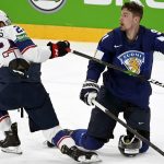 
              Kieffer Bellows of USA, left, and Juho Lammikko of Finland in action during the 2022 IIHF Ice Hockey World Championships preliminary round group B match between Finland and USA in Tampere, Finland, Monday May 16, 2022. (Vesa Moilanen/Lehtikuva via AP)
            