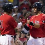 
              Boston Red Sox's Rafael Devers (11) celebrates with J.D. Martinez, right, after both scored on a double by Alex Verdugo during the second inning of the team's baseball game against the Baltimore Orioles at Fenway Park, Friday, May 27, 2022, in Boston. (AP Photo/Mary Schwalm)
            