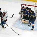 
              Colorado Avalanche's Gabriel Landeskog (92) keeps his eye on the puck as St. Louis Blues goaltender Ville Husso, Tyler Bozak, left, and Niko Mikkola, right, defend during the second period in Game 3 of an NHL hockey Stanley Cup second-round playoff series Saturday, May 21, 2022, in St. Louis. (AP Photo/Jeff Roberson)
            