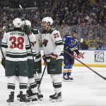 
              Minnesota Wild's Ryan Hartman (38), Jonas Brodin (25) and teammates celebrate a goal against the St. Louis Blues during the first period in Game 3 of an NHL hockey Stanley Cup first-round playoff series Friday, May 6, 2022, in St. Louis. (AP Photo/Michael Thomas)
            