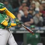 
              Oakland Athletics' Elvis Andrus hits a single to score Sean Murphy during the seventh inning of the team's baseball game against the Seattle Mariners, Tuesday, May 24, 2022, in Seattle. (AP Photo/Ted S. Warren)
            