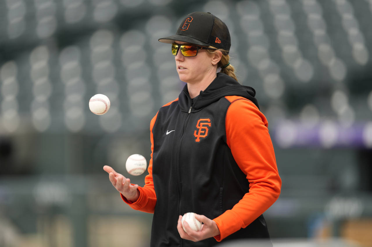 San Francisco Giants major league assistant coach Alyssa Nakken juggles baseballs as players warm u...