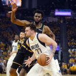 
              Dallas Mavericks guard Luka Doncic (77) dribbles the ball next to Golden State Warriors forward Andrew Wiggins during the first half in Game 5 of the NBA basketball playoffs Western Conference finals in San Francisco, Thursday, May 26, 2022. (AP Photo/Jeff Chiu)
            