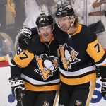
              Pittsburgh Penguins' Jeff Carter (77) celebrates his second goal, an empty-net goal during the third period, with Sidney Crosby in Game 3 of an NHL hockey Stanley Cup first-round playoff series against the New York Rangers in Pittsburgh, Saturday, May 7, 2022. (AP Photo/Gene J. Puskar)
            
