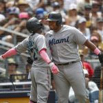 
              CORRECTS CHISHOLM'S TEAM TO MIAMI MARLINS INSTEAD OF SAN DIEGO PADRES - Miami Marlins' Jazz Chisholm Jr celebrates with teammate Jesus Aguilar after hitting a solo home run against the San Diego Padres during the sixth inning of a baseball game, Sunday, May 8, 2022, in San Diego. (AP Photo/Mike McGinnis)
            