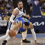 
              Golden State Warriors forward Otto Porter Jr. (32) and Memphis Grizzlies forward Dillon Brooks, top, struggle for control of the ball during Game 1 of a second-round NBA basketball playoff series Sunday, May 1, 2022, in Memphis, Tenn. (AP Photo/Brandon Dill)
            