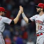 
              Cincinnati Reds' Tyler Naquin (12) and Mike Moustakas (9) celebrate the team's 5-4 win over the Cleveland Guardians in 10 innings in a baseball game Tuesday, May 17, 2022, in Cleveland. (AP Photo/Ron Schwane)
            