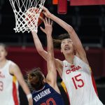 
              FILE - China's Han Xu (15) shoots over Serbia's Tina Krajisnik during a women's basketball quarterfinal at the 2020 Summer Olympics, Aug. 4, 2021, in Saitama, Japan. After missing the last two seasons while she stayed at home in China, dealing with the COVID lockdowns and training for the Olympics, Han is back in New York. The 22-year-old has grown an inch, standing at 6-foot-10 now and feels more ready to play in the WNBA. (AP Photo/Charlie Neibergall, File)
            