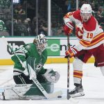 
              Dallas Stars goaltender Jake Oettinger (29) blocks a shot by Calgary Flames left wing Matthew Tkachuk (19) in the second period of Game 4 of an NHL hockey Stanley Cup first-round playoff series, Monday, May 9, 2022, in Dallas. (AP Photo/Tony Gutierrez)
            