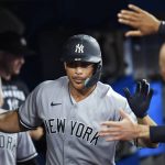 
              New York Yankees' Giancarlo Stanton (27) is congratulated after scoring against the Toronto Blue Jays during the seventh inning of a baseball game Tuesday, May 3, 2022, in Toronto. (Nathan Denette/The Canadian Press via AP)
            