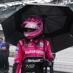 
              Helio Castroneves, of Brazil, walk out of the pit area as rain halted qualifications for the Indianapolis 500 auto race at Indianapolis Motor Speedway in Indianapolis, Saturday, May 21, 2022. (AP Photo/Michael Conroy)
            
