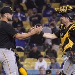 
              Pittsburgh Pirates relief pitcher Wil Crowe, left, celebrates with catcher Tyler Heineman after Los Angeles Dodgers' Freddie Freeman grounded out to end their baseball game Tuesday, May 31, 2022, in Los Angeles. The Pirates won 5-3. (AP Photo/Mark J. Terrill)
            