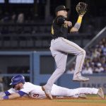 
              Los Angeles Dodgers' Gavin Lux, left, steals second as Pittsburgh Pirates second baseman Diego Castillo takes a late throw during the fourth inning of a baseball game Tuesday, May 31, 2022, in Los Angeles. (AP Photo/Mark J. Terrill)
            
