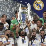 
              Real Madrid's Marcelo lifts the trophy as players celebrate winning the Champions League final soccer match between Liverpool and Real Madrid at the Stade de France in Saint Denis near Paris, Saturday, May 28, 2022. (AP Photo/Frank Augstein)
            
