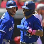
              Toronto Blue Jays' Bo Bichette, right, is congratulated by George Springer after scoring a run on a two-RBI single by Teoscar Hernandez in the first inning of a baseball game against the Cleveland Guardians, Sunday, May 8, 2022, in Cleveland. (AP Photo/David Dermer)
            