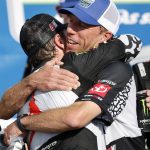 
              Billy Scott, crew chief for 23XI Racing, right, hugs driver, Kurt Busch, left, in Victory Lane follow Busch's win of a NASCAR Cup Series auto race at Kansas Speedway in Kansas City, Kan., Sunday, May 15, 2022. (AP Photo/Colin E. Braley)
            