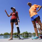 
              Jacky Hunt-Broersma, left, stands next to her husband, Edwin Broersma, as Jacky talks about finishing her 102nd marathon in 102 days, this one at Veterans Oasis Park, Thursday, April 28, 2022, in Chandler, Ariz. (AP Photo/Ross D. Franklin)
            