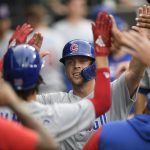
              Chicago Cubs' Nico Hoerner celebrates in the dugout after scoring on a Andrelton Simmons groundout during the second inning of a baseball game against the Chicago White Sox at Guaranteed Rate Field, Saturday, May 28, 2022, in Chicago. (AP Photo/Paul Beaty)
            