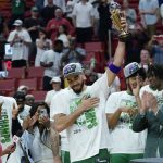 
              Boston Celtics forward Jayson Tatum raises the NBA Eastern Conference MVP trophy after defeating the Miami Heat in Game 7 of the NBA basketball Eastern Conference finals playoff series, Sunday, May 29, 2022, in Miami. (AP Photo/Lynne Sladky)
            