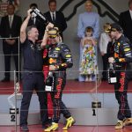 
              Red Bull driver Sergio Perez of Mexico celebrates on the podium as Team chief Christian Horner of Red Bull Racing sprays champagne on his head after winning the Monaco Formula One Grand Prix, at the Monaco racetrack, in Monaco, Sunday, May 29, 2022. At right is third placed Red Bull driver Max Verstappen of the Netherlands. (AP Photo/Daniel Cole)
            