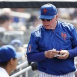 
              New York Mets manager Buck Showalter (11) stands in the dugout during the sixth inning of a baseball game against the Seattle Mariners, Sunday, May 15, 2022, in New York. (AP Photo/Noah K. Murray)
            