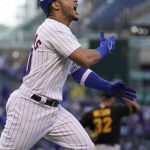 
              Chicago Cubs' Willson Contreras celebrates his grand slam off Pittsburgh Pirates relief pitcher Bryse Wilson, background, during the first inning of a baseball game Monday, May 16, 2022, in Chicago. (AP Photo/Charles Rex Arbogast)
            
