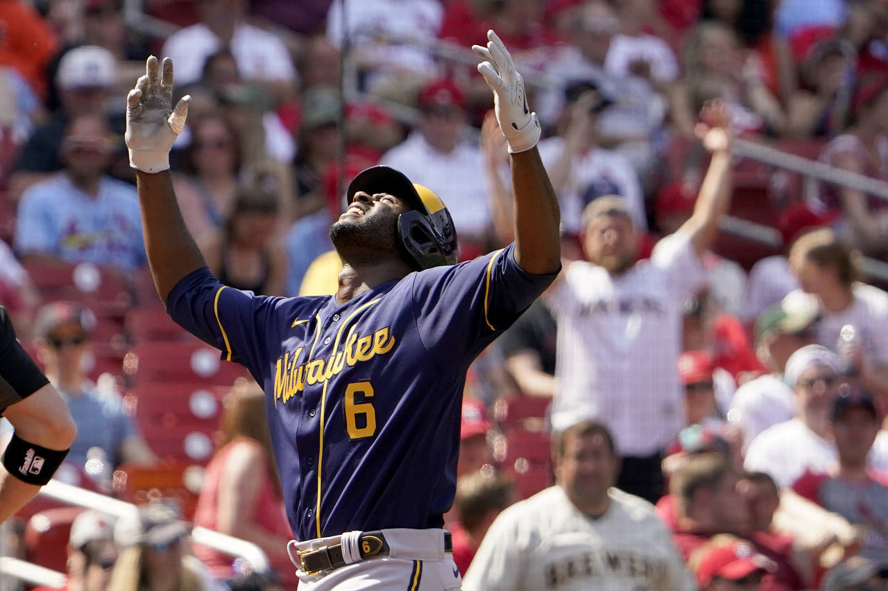 Milwaukee Brewers' Lorenzo Cain celebrates as he arrives home after hitting a two-run home run duri...