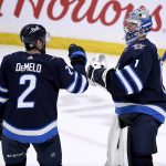 
              Winnipeg Jets' goaltender Eric Comrie (1) celebrates a win over the Seattle Kraken with Dylan DeMelo (2) in NHL hockey game action in Winnipeg, Manitoba, Sunday, May 1, 2022. (Fred Greenslade/The Canadian Press via AP)
            
