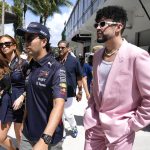 
              Red Bull driver Sergio Perez, of Mexico, left, walks in the paddock with Puerto Rican reggaeton musician Bad Bunny, right, before a Formula One Miami Grand Prix auto race at Miami International Autodrome, Sunday, May 8, 2022, in Miami Gardens, Fla. (AP Photo/Lynne Sladky)
            