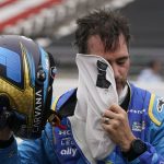 
              Jimmie Johnson takes off his balaclava during qualifications for the Indianapolis 500 auto race at Indianapolis Motor Speedway, Saturday, May 21, 2022, in Indianapolis. (AP Photo/Darron Cummings)
            