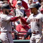 
              Arizona Diamondbacks' Christian Walker, left, is congratulated by teammate Ketel Marte (4) after hitting a solo home run during the fourth inning of a baseball game against the St. Louis Cardinals Sunday, May 1, 2022, in St. Louis. (AP Photo/Jeff Roberson)
            