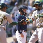 
              Oakland Athletics' Elvis Andrus (17) greets Christian Bethancourt (23) at the plate after Andrus hit a two-run home run to score Bethancourt during the sixth inning of a baseball game against the Seattle Mariners, Wednesday, May 25, 2022, in Seattle. (AP Photo/Ted S. Warren)
            