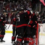 
              Carolina Hurricanes players celebrate around goaltender Antti Raanta following their win over the Boston Bruins in Game 7 of an NHL hockey Stanley Cup first-round playoff series in Raleigh, N.C., Saturday, May 14, 2022. (AP Photo/Karl B DeBlaker)
            