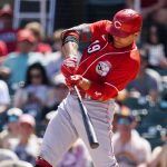 
              Cincinnati Reds' Joey Votto connects for an RBI double against the Arizona Diamondbacks during the second inning of a spring training baseball game Sunday, April 3, 2022, in Scottsdale, Ariz. (AP Photo/Ross D. Franklin)
            
