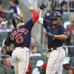 
              Boston Red Sox's Rafael Devers, right, celebrates his grand slam off Atlanta Braves starting pitcher Kyle Wright with Enrique Hernandez (5) during the second inning of a  baseball game on Tuesday, May 10, 2022, in Atlanta. (Curtis Compton/Atlanta Journal-Constitution via AP)
            
